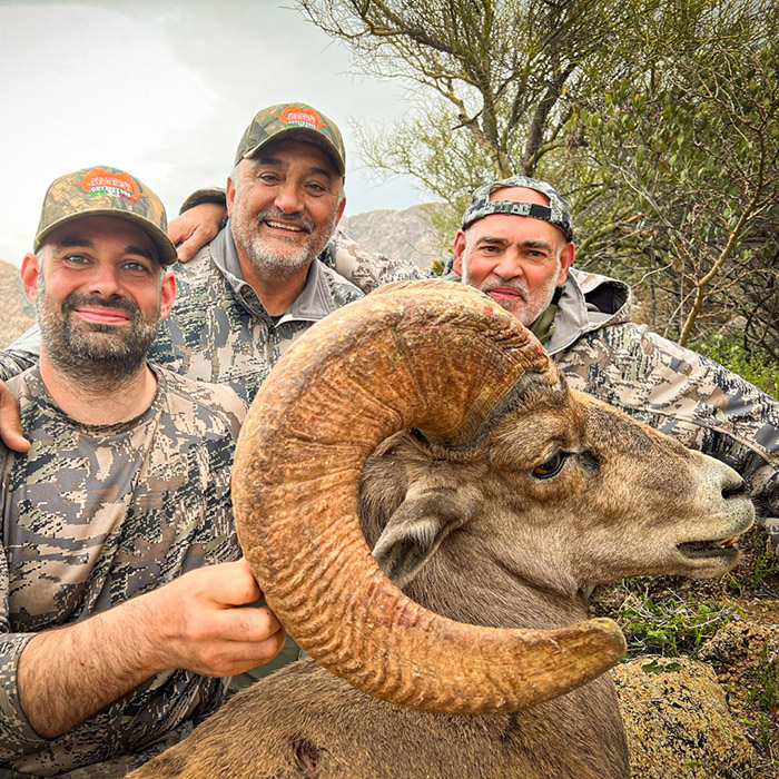 Group of guides and a hunter with a desert bighorn